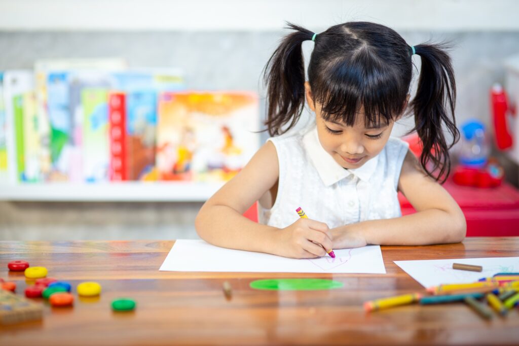 Preschooler child girl drawing and coloring