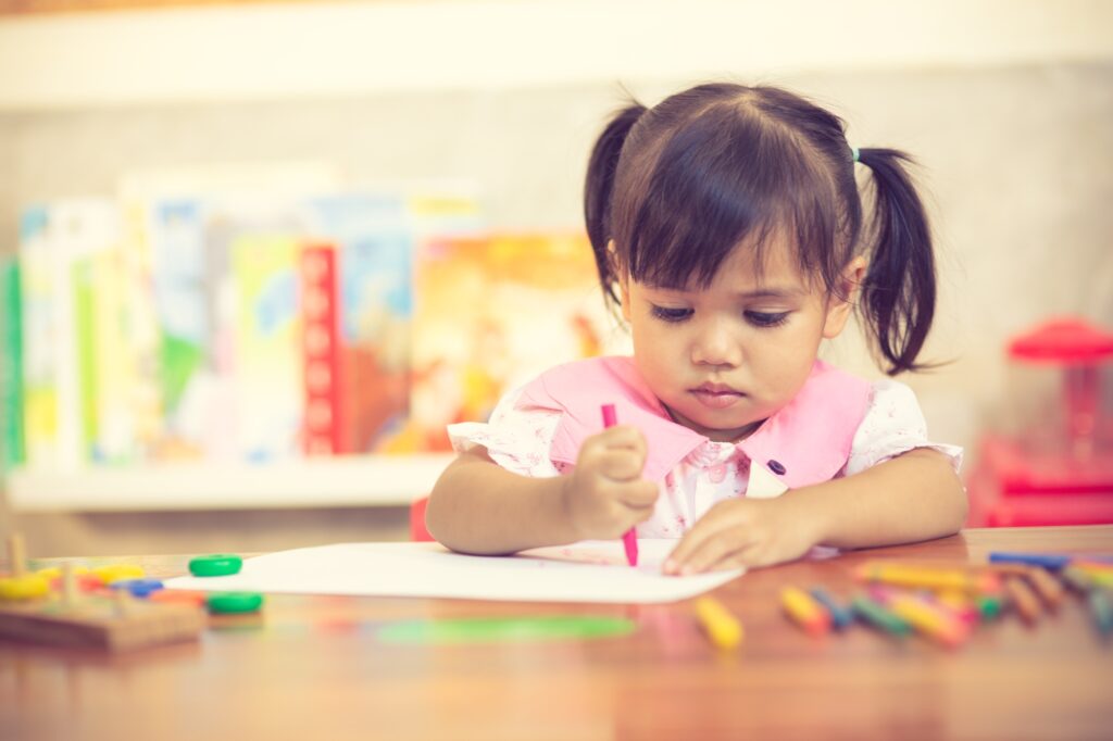 Preschooler child girl drawing and coloring