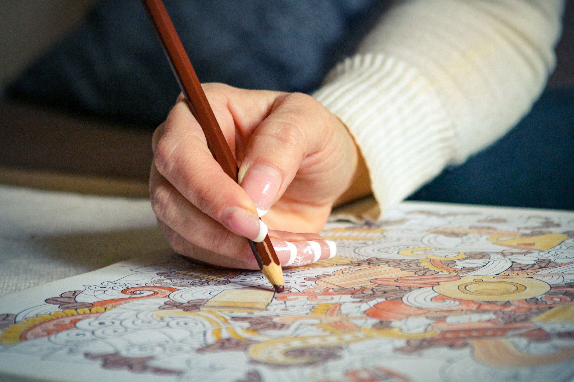 A hand of a woman coloring the color book