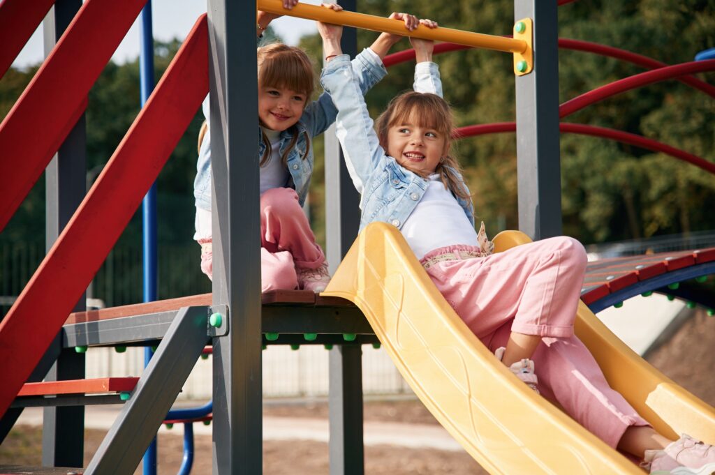 On the playground slide. Kids are having fun
